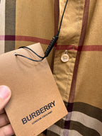 Burberry fabric tag on beige plaid shirt with button placket