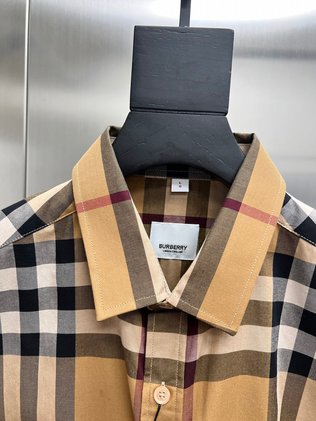 Burberry plaid button-up shirt, beige spread collar and button placket close-up
