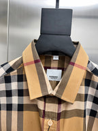 Burberry plaid button-up shirt, beige spread collar and button placket close-up