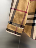 Burberry plaid long-sleeve shirt hem with light trim at sleeve cuff