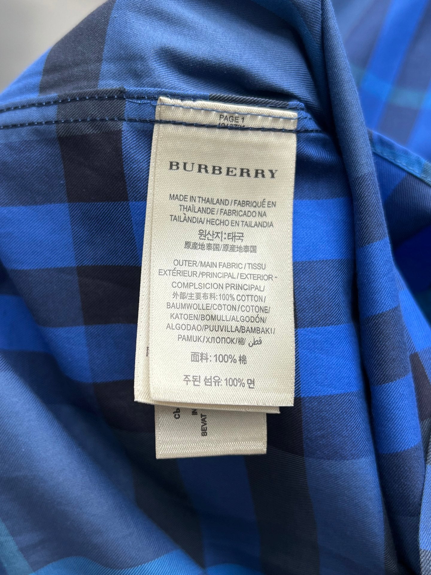 Burberry plaid long-sleeve shirt collar label with care information.