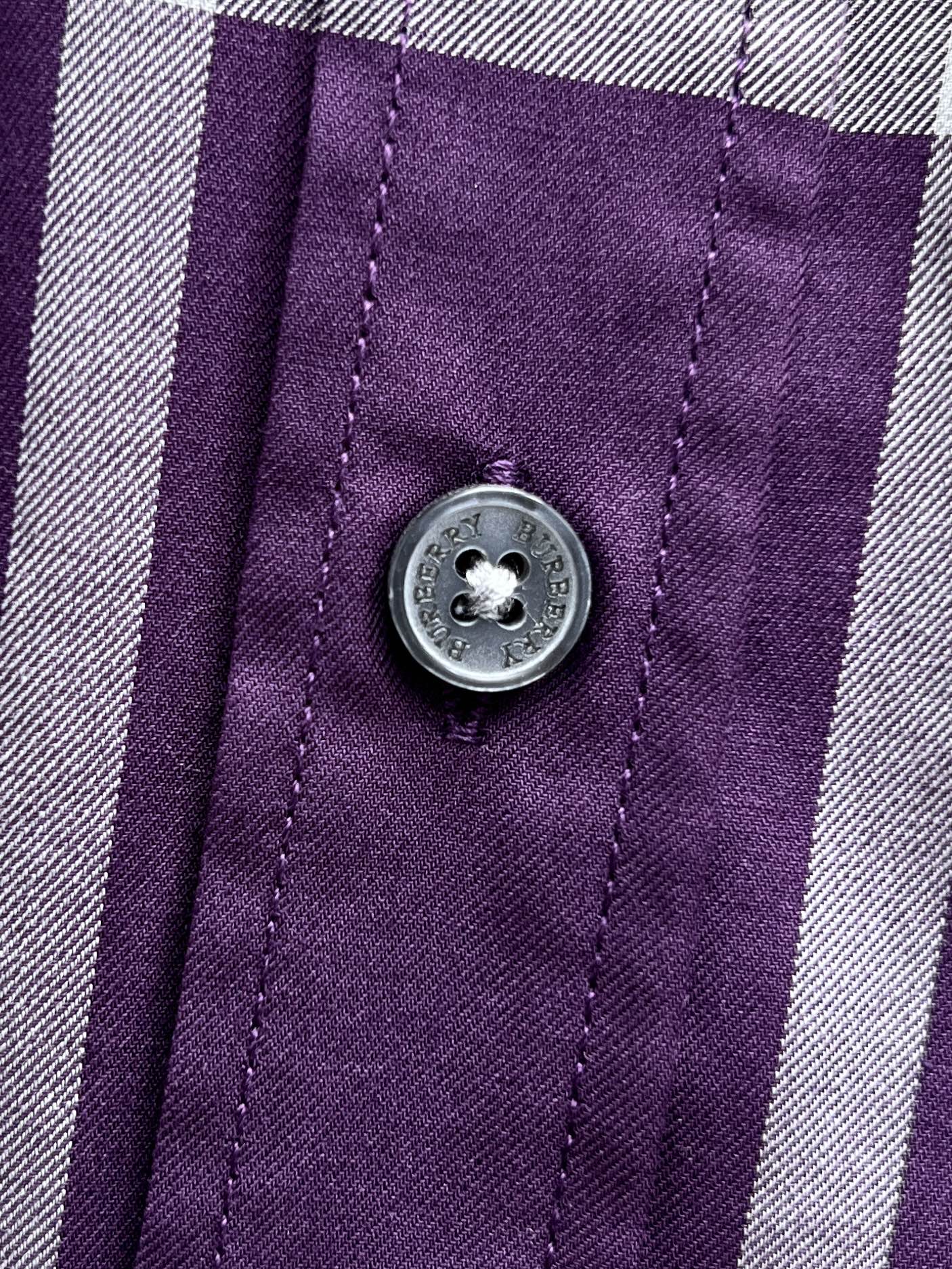 Burberry plaid shirt button detail on purple fabric with white trim