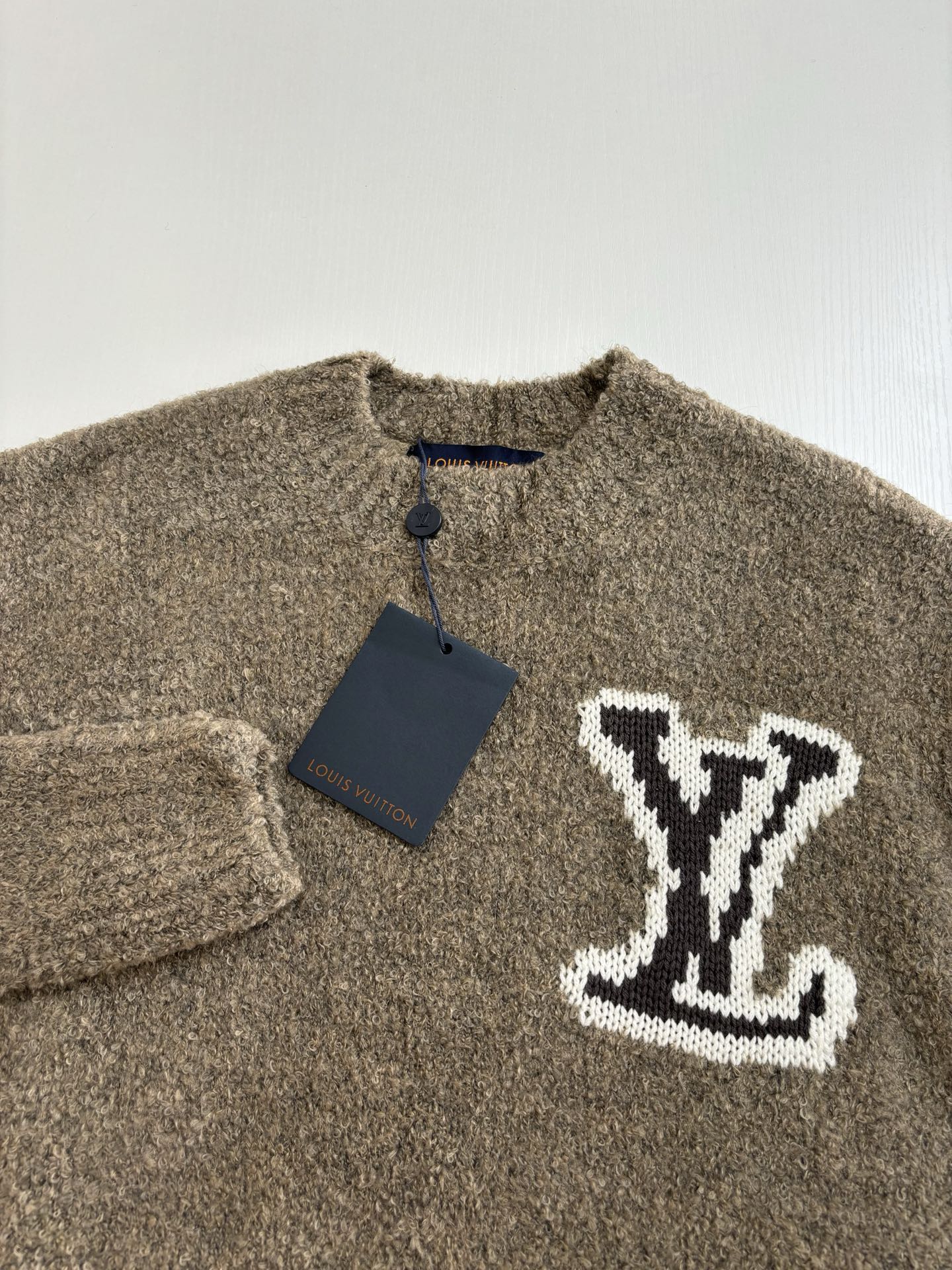 Brown knit sweater with buttoned collar and white LV monogram applique