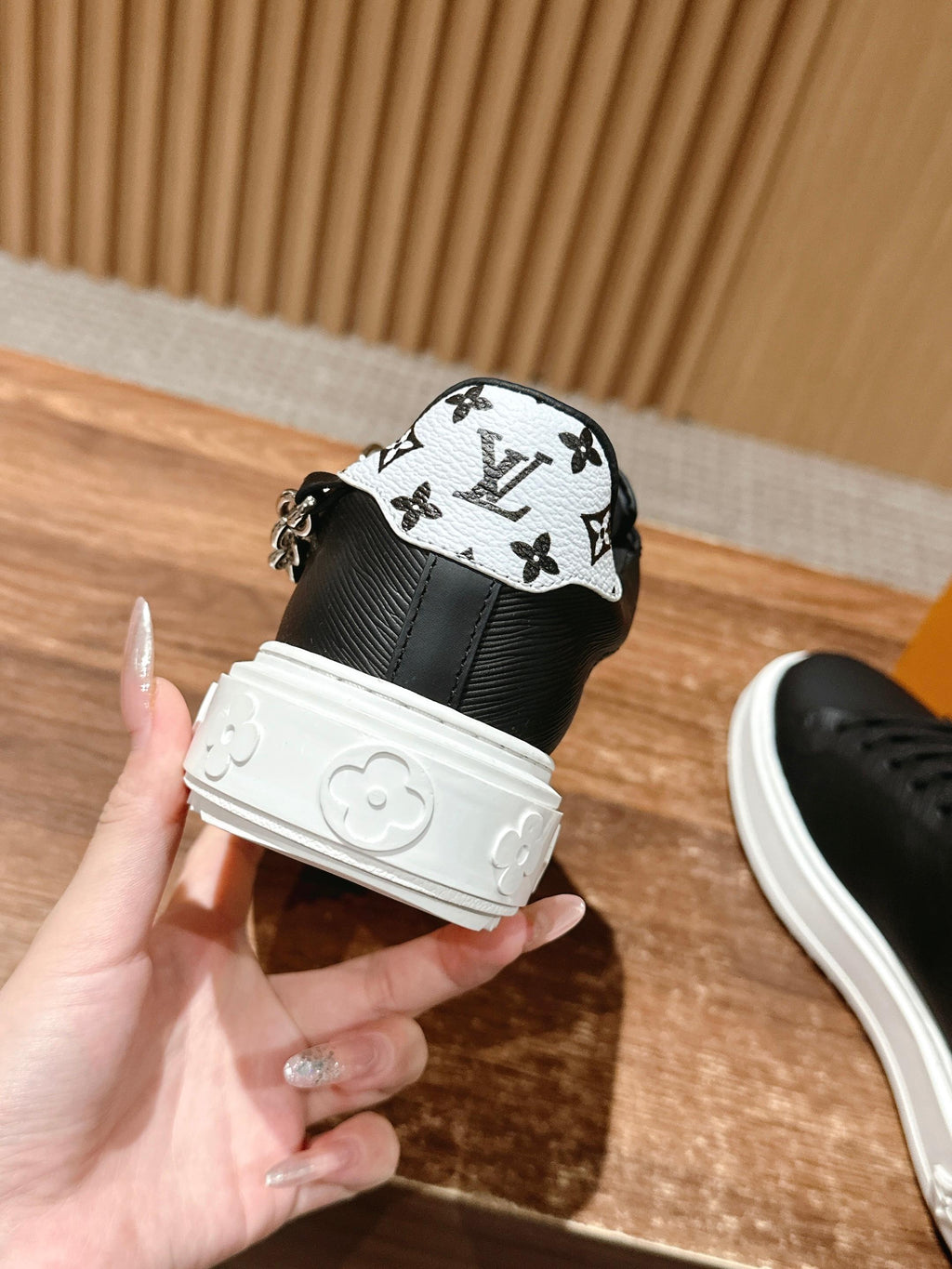 Louis Vuitton lace-up sneakers, black with monogram heel, white sole, close-up