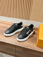 Louis Vuitton lace-up sneakers, black, white sole, angled pair with chain detail