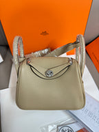 Taupe textured leather mini handbag with flap and braided shoulder strap