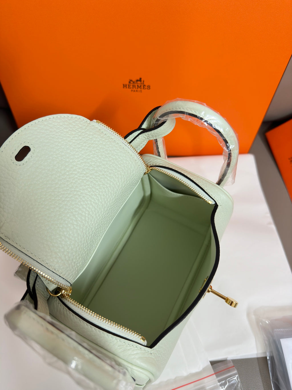 Hermes mint leather handbag open top with zip pocket and light interior