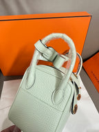 Hermes mint leather handbag with curved handles and side detail pockets