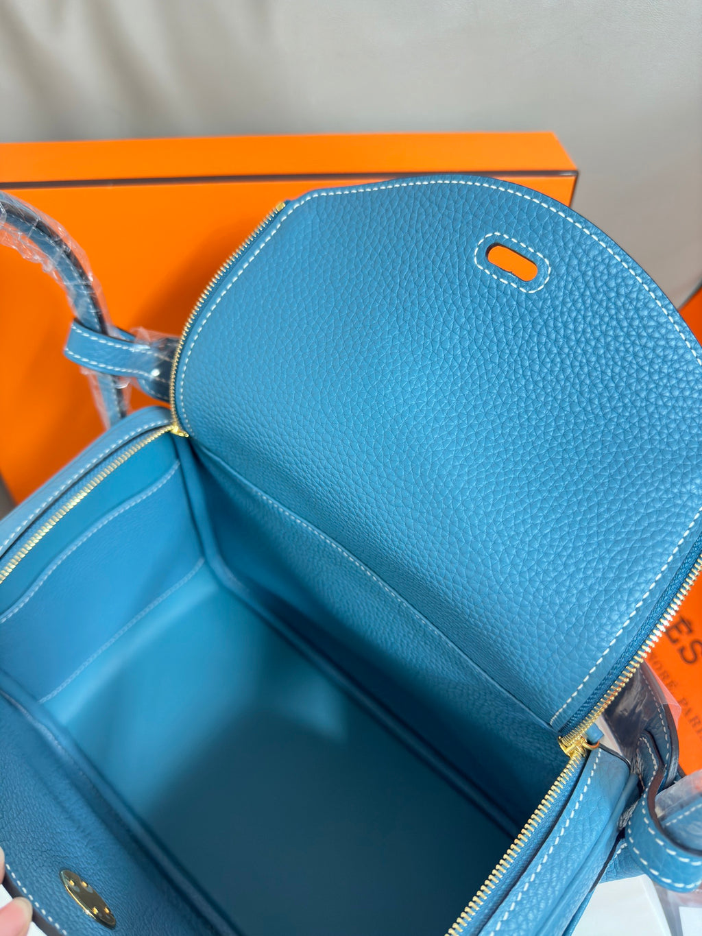 Hermes blue leather handbag interior view with zip opening and lined compartment