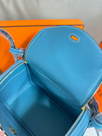 Hermes blue leather handbag interior view with zip opening and lined compartment