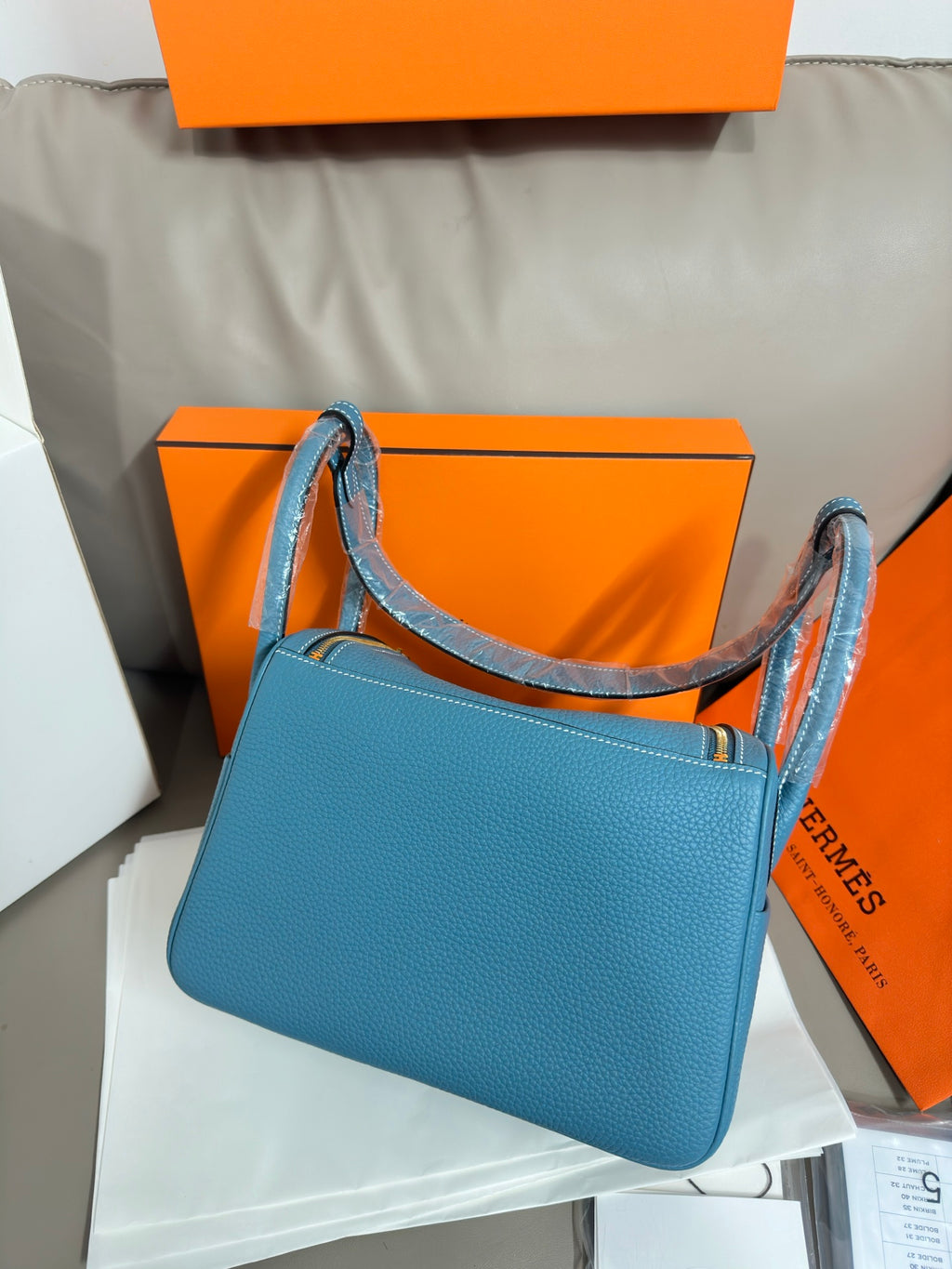 Hermes blue leather handbag with long handles and structured shoulder strap