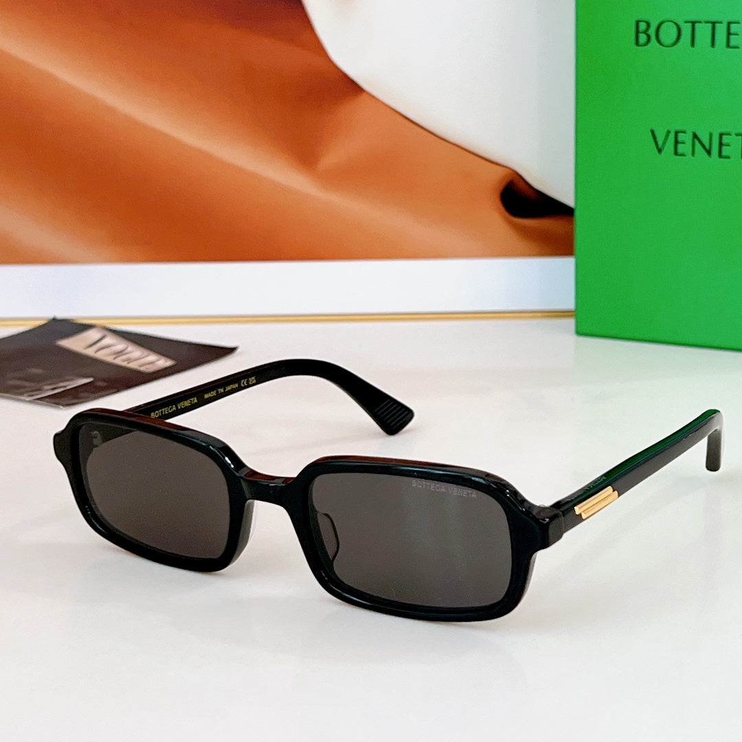 Bvlgari sunglasses: dark frames with smoke lenses and gold-tone temple accents.