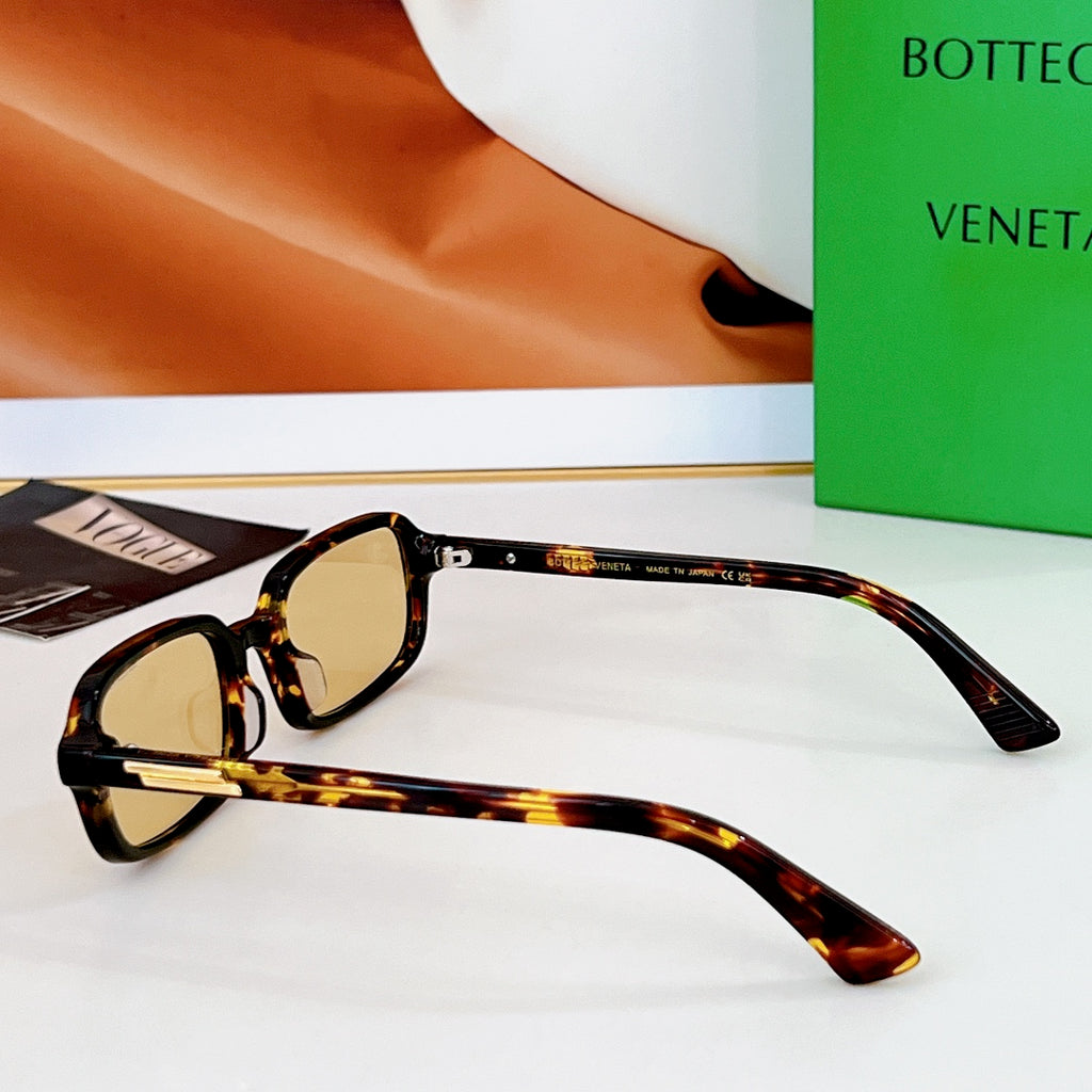 Bvlgari sunglasses: tortoiseshell frames with amber lenses and gold-tone hinges.