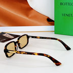 Bvlgari sunglasses: tortoiseshell frames with amber lenses and gold-tone hinges.