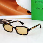 Bvlgari sunglasses: dark tortoiseshell frames with light amber lenses and gold detail.