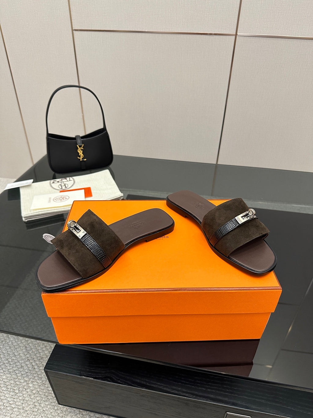 Pair of ladies’ suede slide sandals with silver buckle strap and cushioned footbed