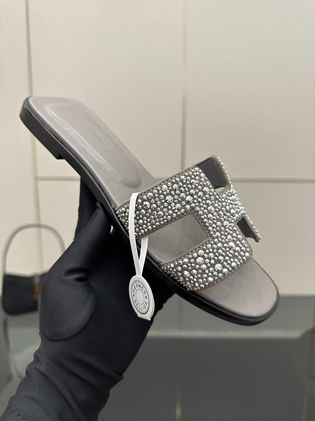 Women's rhinestone slide sandal, gray upper with sparkling H-style ornament on strap