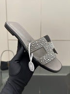 Women's rhinestone slide sandal, gray upper with sparkling H-style ornament on strap