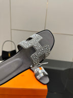 Women's rhinestone slide sandal close-up, gray slide with silver crystal buckle strap