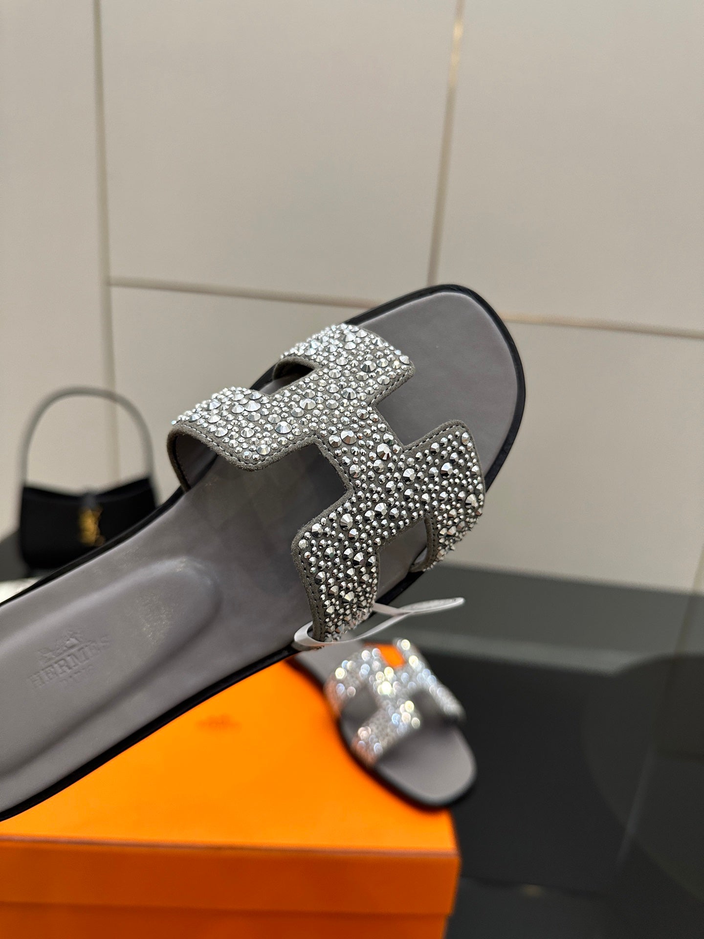 Women's rhinestone slide sandal close-up, gray slide with silver crystal buckle strap