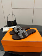 Hermes ladies slide sandals, black with silver rhinestone H buckle, front view