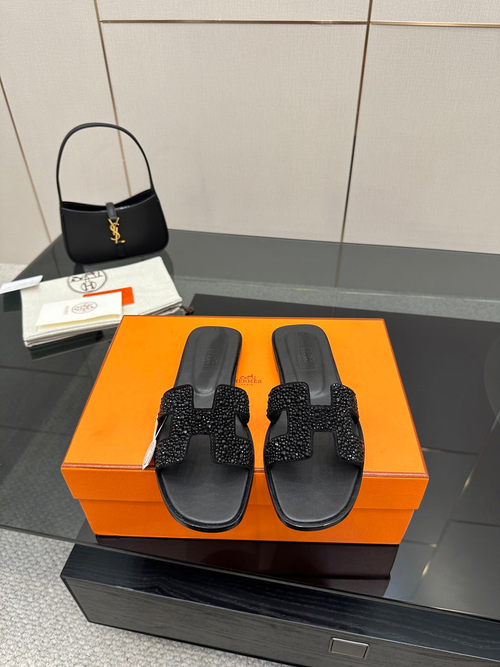 Black slide sandals with rhinestone cross-strap and open toe