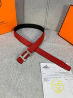 Hermes belt flat with red strap, gold buckle hardware, black edge and hole details.
