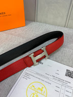 Hermes belt red-and-black leather with metal buckle and punched adjustment holes.