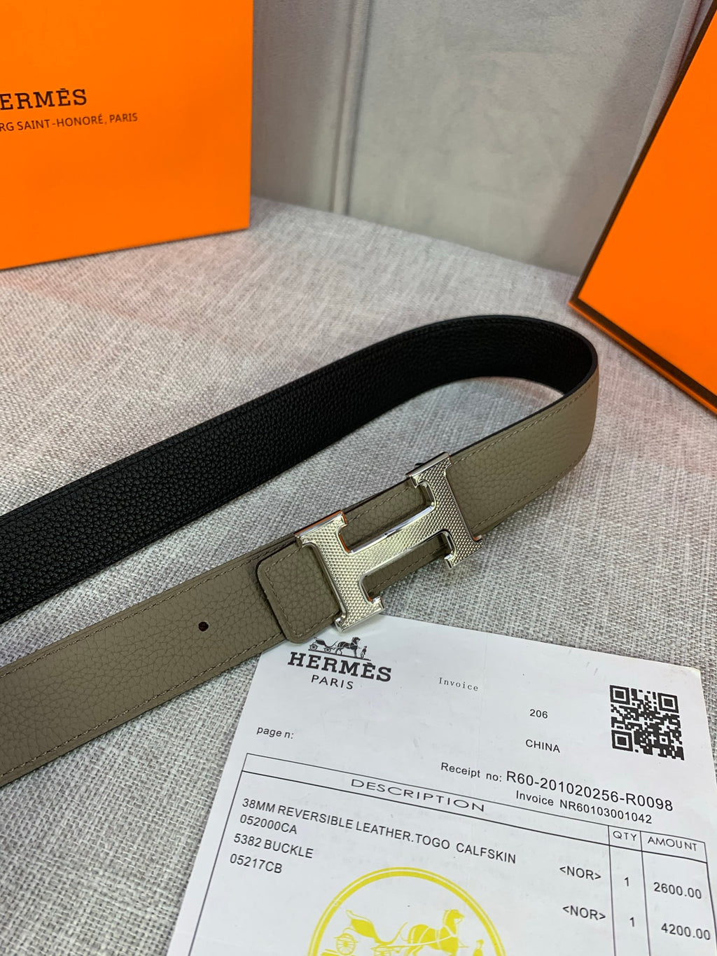 Black leather belt with silver H buckle, shown flat on documents