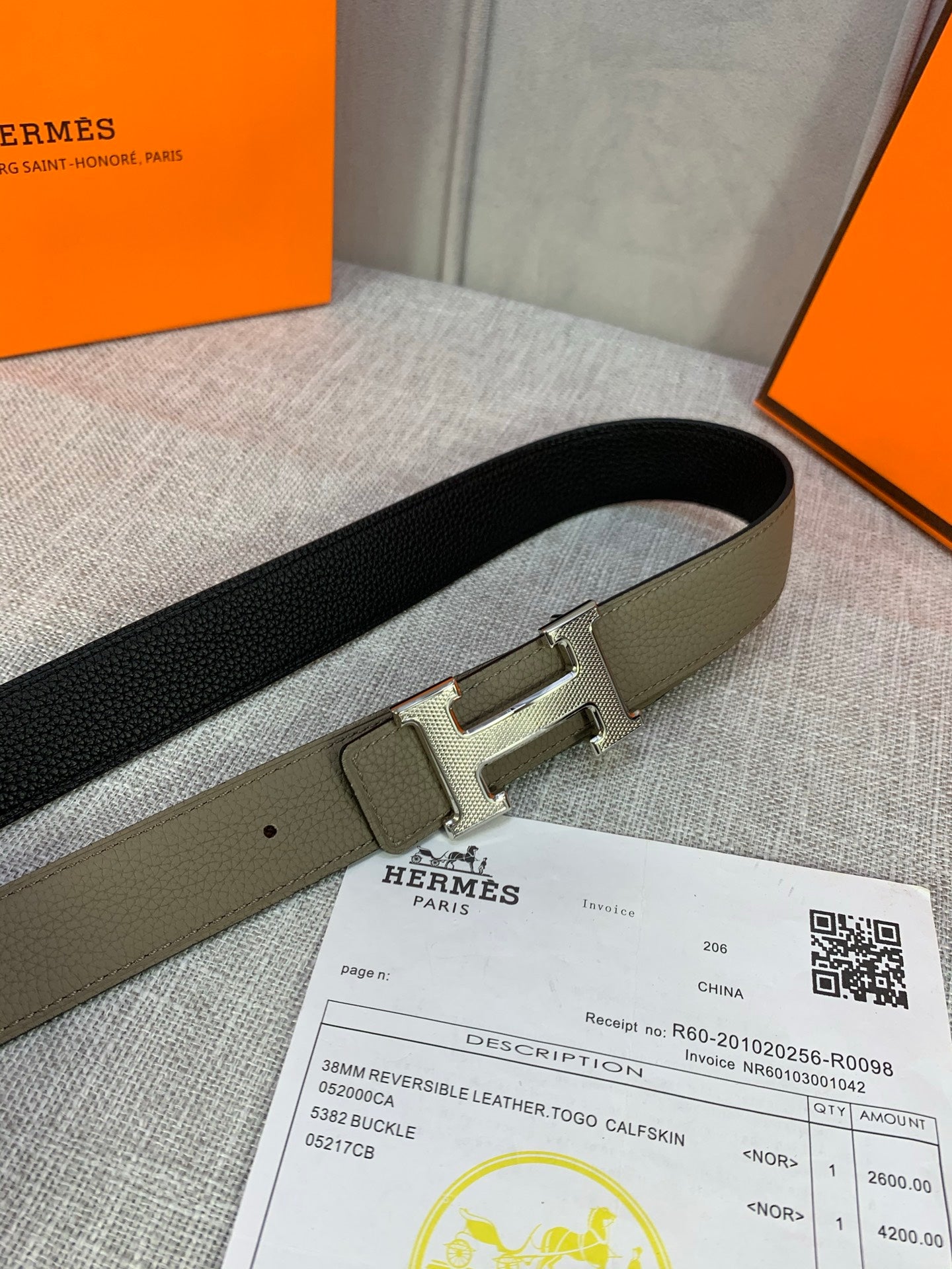 Black leather belt with silver H buckle, shown flat on documents