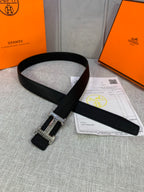 Black textured leather belt with silver-tone buckle and end strap
