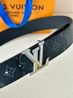 Louis Vuitton belt close-up: dark monogram strap with silver LV buckle