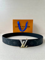 Louis Vuitton belt with dark monogram strap and silver LV buckle, front view
