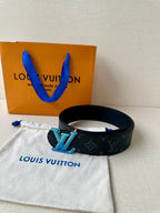 Louis Vuitton dark monogram belt with blue LV buckle, shown laid flat