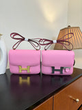 Pink leather handbag with front flap and gold H clasp, bow-tie handle detail