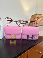 Pink leather handbag with front flap and gold H clasp, bow-tie handle detail