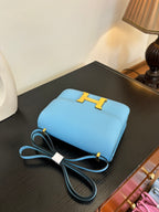 Hermes H bag light blue with gold H clasp, flat top, and attached strap cords