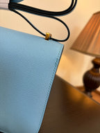 Hermes H bag light blue leather corner detail with black cord handle and gold clasp
