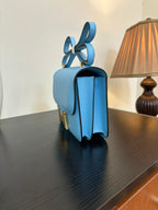 Hermes H bag in light blue with gold hardware and curved strap handles