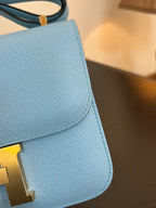 Hermes H bag light blue pebbled leather with gold H clasp detail on flap