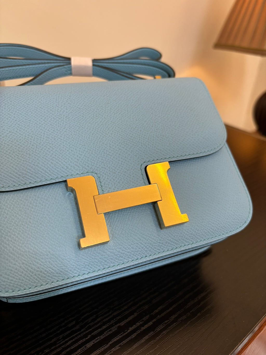 Hermes H bag light blue flap with gold H clasp and visible handle strap loops