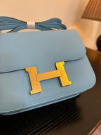 Hermes H bag light blue flap with gold H clasp and visible handle strap loops