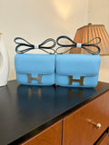 Hermes H bag in light blue with gold H front clasp and top handle straps