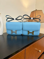 Hermes H bag in light blue with gold H front clasp and top handle straps
