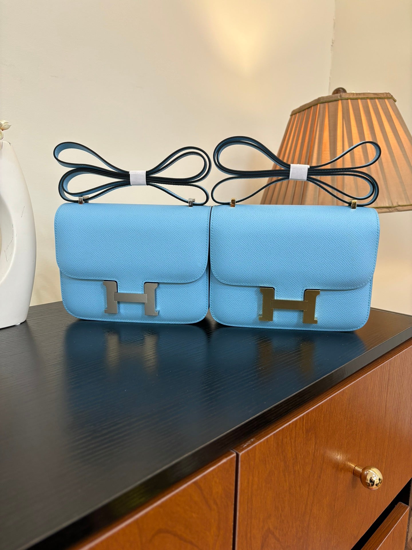 Hermes H bag in light blue with gold H front clasp and top handle straps