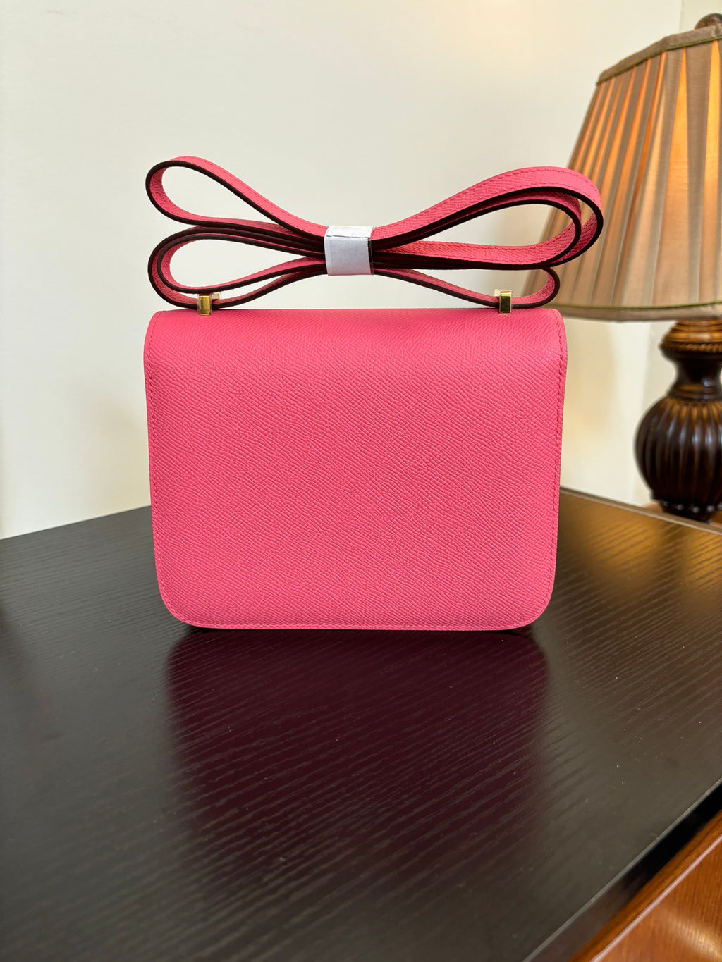 Hermes pink leather mini shoulder bag with flap and gold H hardware, front view.