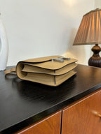 Beige leather-look shoulder bag with flap open and H clasp detail