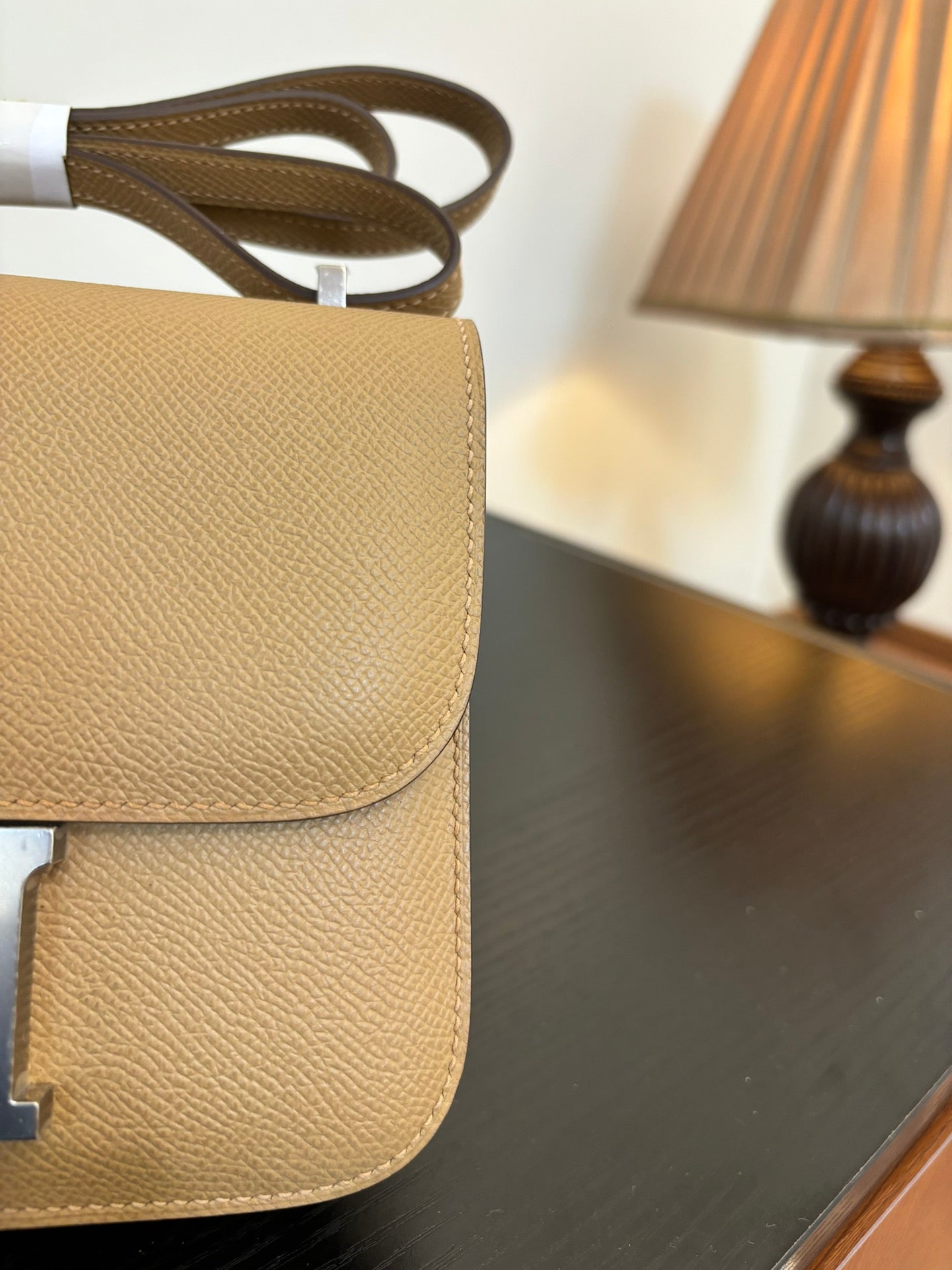 Beige leather-look bag back view with stacked flap and strap loop