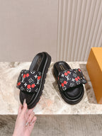 Louis Vuitton slide sandals, black with multicolor monogram print and thick sole.