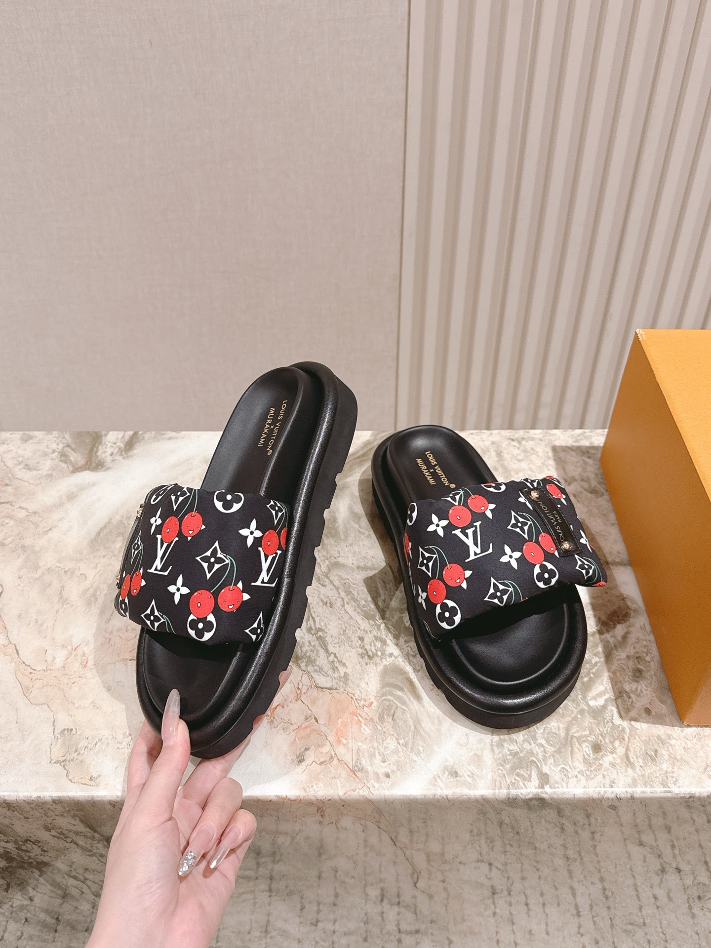 Louis Vuitton slide sandals, black with multicolor monogram print and thick sole.
